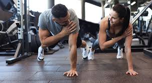 Sculpting Sleek Arms: The Essential Role of Cardio in Toning Without Bulking Up 1 Image of man and woman doing Cardio Romford to tone their arms.